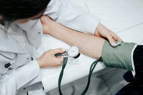 Healthcare professional checking blood pressure