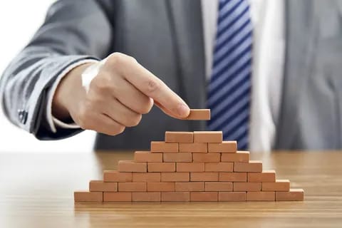 Wooden blocks stacked in a pyramid on a table