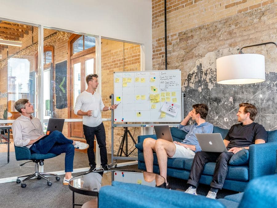 Team collaborating around a whiteboard with sticky notes