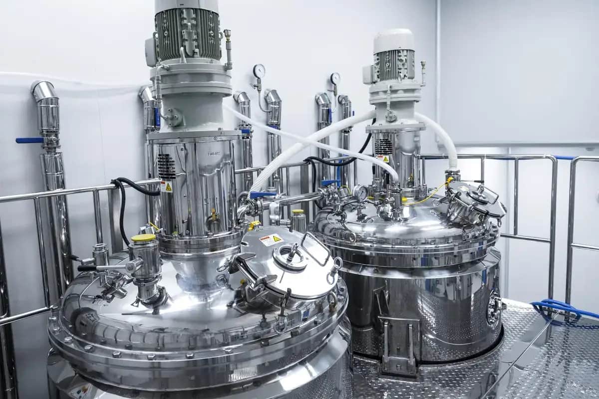 Stainless steel tanks and piping inside a beverage manufacturing plant