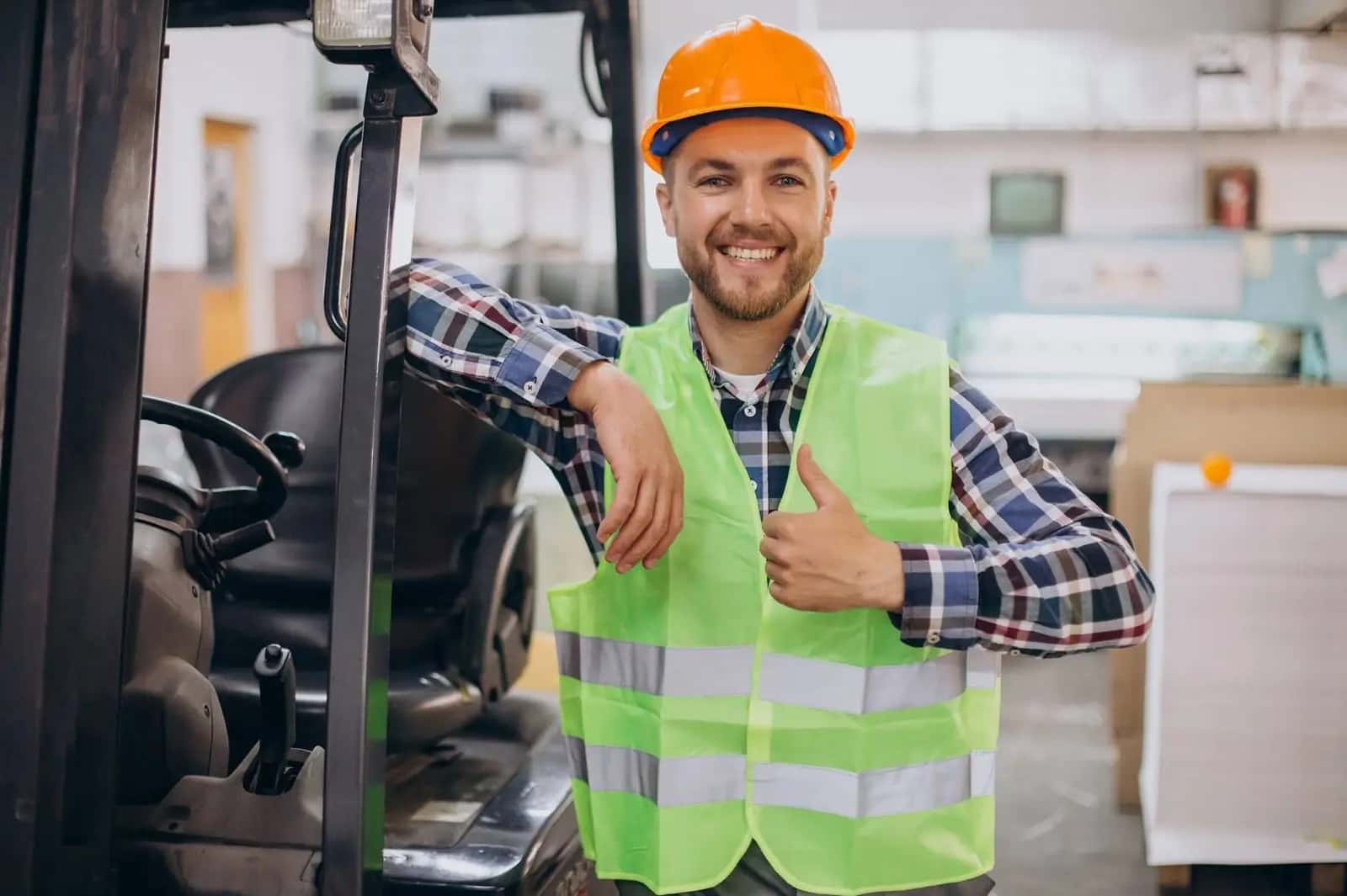 Warehouse worker in a safety vest giving a thumbs up